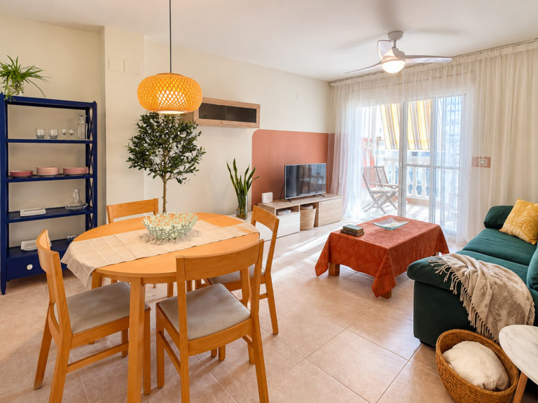 Salón y comedor de Ático MarLuc en El Campello, con mesa redonda y zona de estar